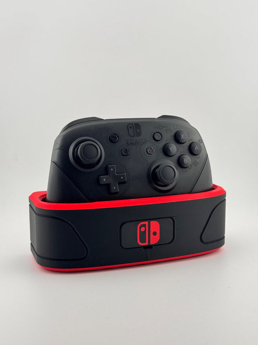 Nintendo Switch Pro Controller fully visible in a black-and-red controller dock with Switch emblem on the front