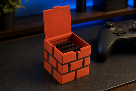 Brick-style magnetic game cartridge holder on a gaming desk with generic game cards